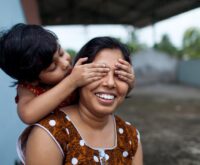 Mother and her kid is playing together