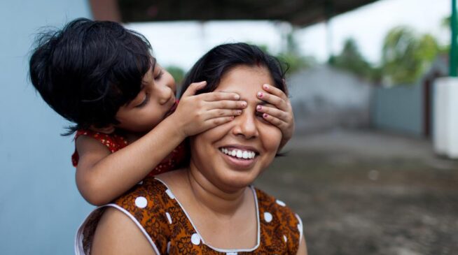 Mother and her kid is playing together