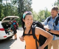 Couple carrying a backpack