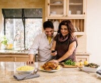 Couple looking at food in kitchen