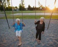 Two old ladies enjoying on a swing