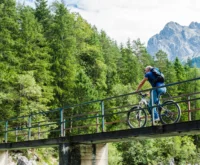 Jogger jumping through flowing water on sunny day