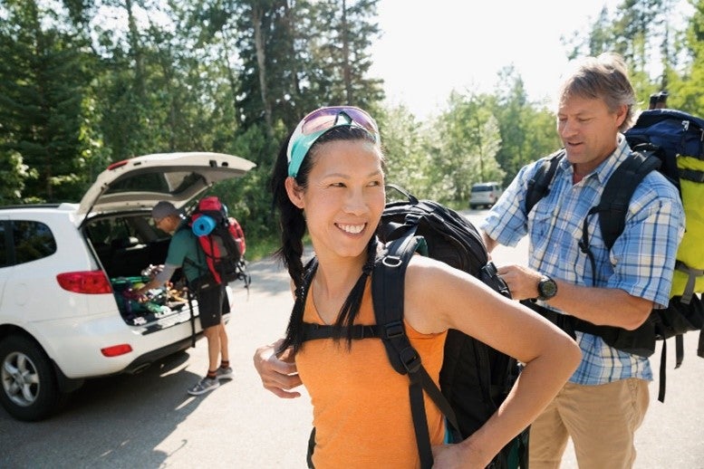 Couple carrying a backpack