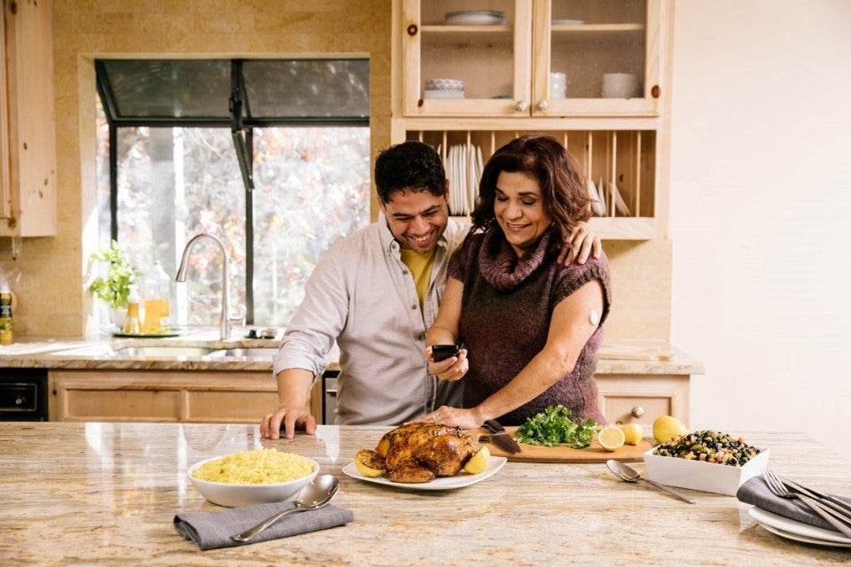 Couple looking at food in kitchen