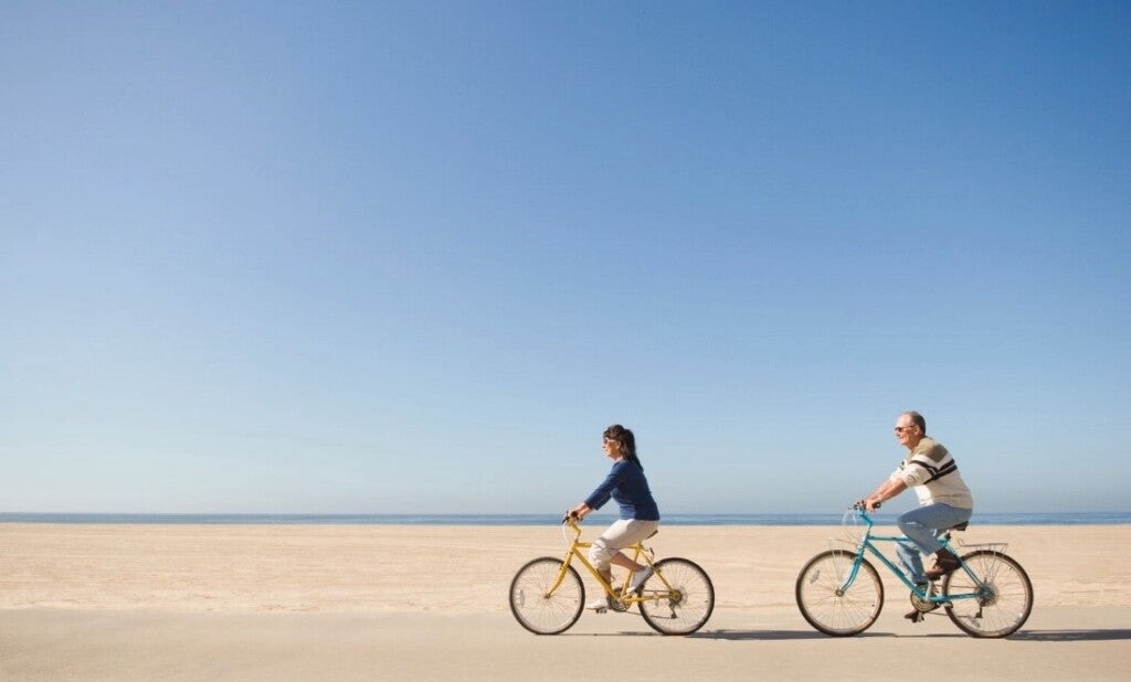 Couple cycling on a sea beach