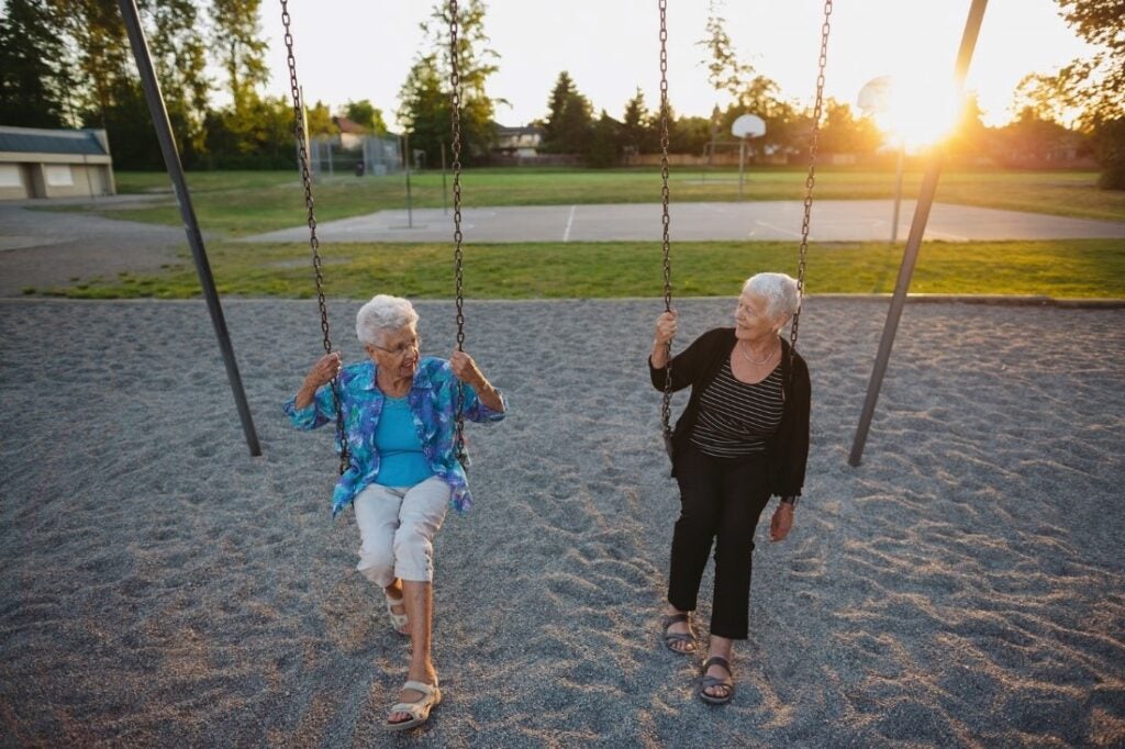 Two old ladies enjoying on a swing