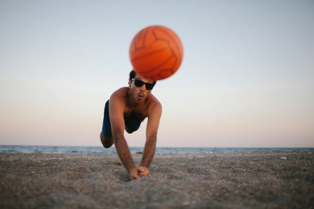 Man playing volleyball on the sea beach