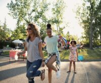 Two young women happily skipping rope together